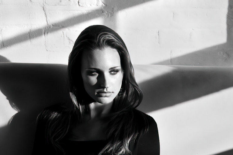A woman standing in front of a window