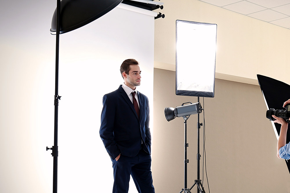 A man standing in front of a mirror posing for the camera. Corporate Headshots services