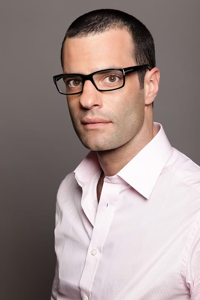 A man wearing glasses and looking at the camera