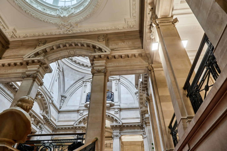 A large clock mounted to the side of a building