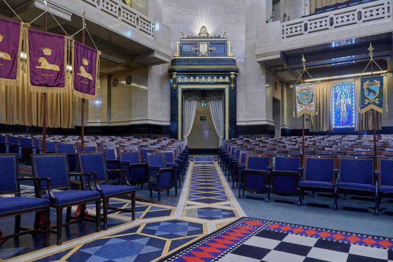 A group of people sitting in front of a building