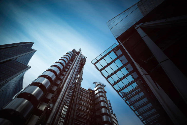 A large tall tower with a clock on the side of a building