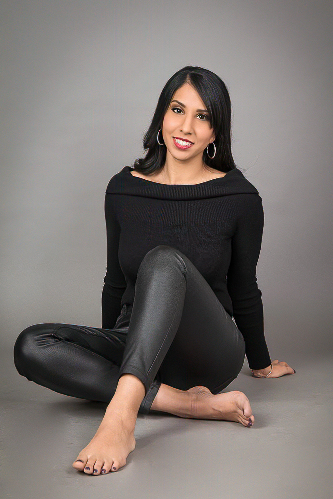 A woman sitting posing for the camera