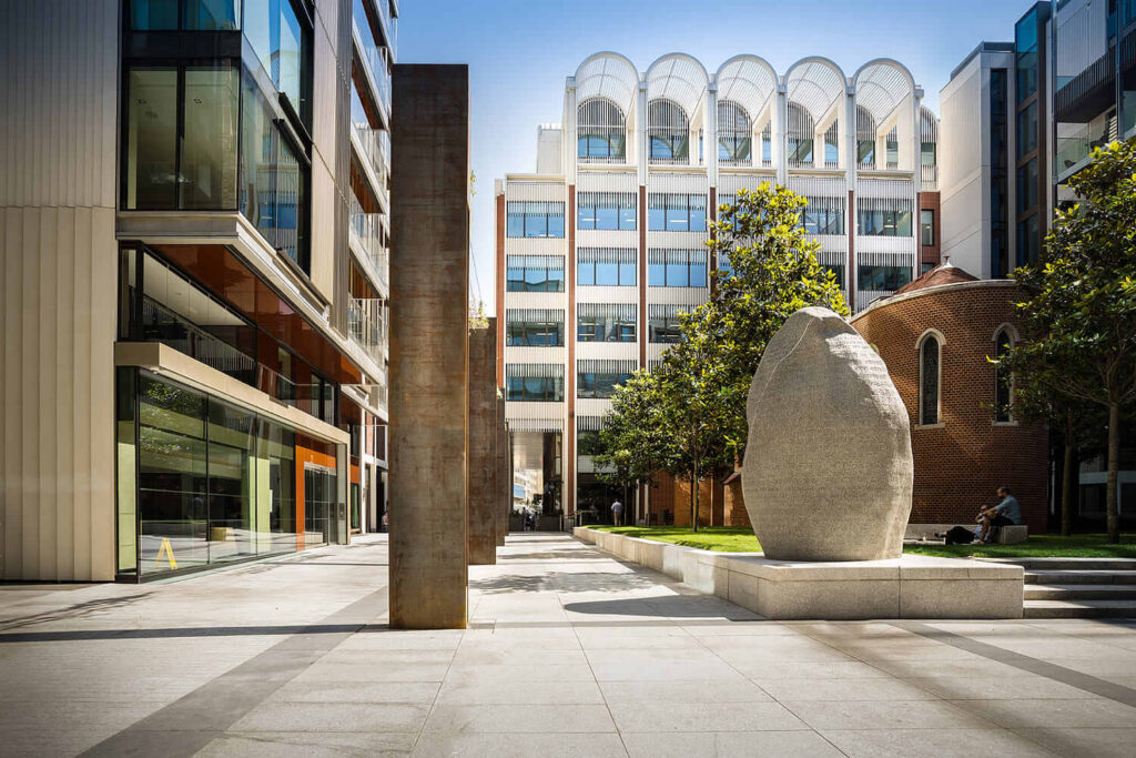 A statue on a sidewalk next to a building