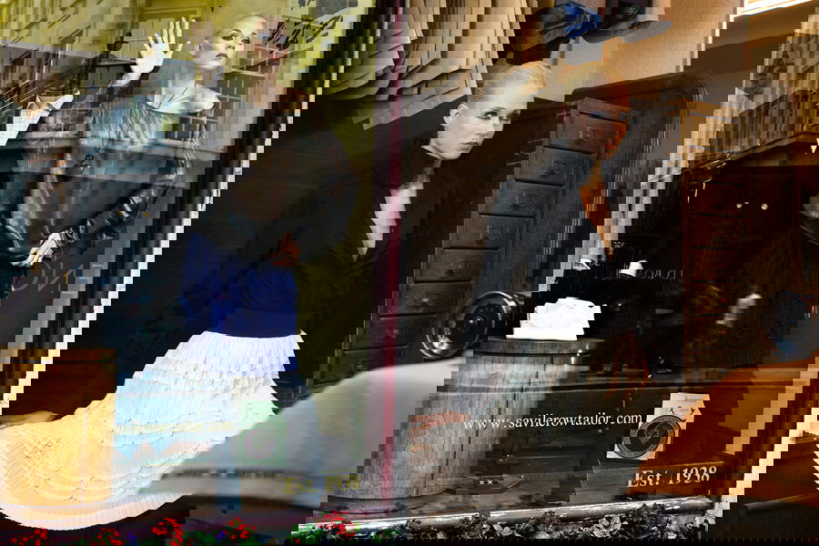 A man and a woman standing in front of a mirror