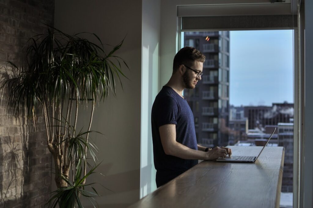 A person standing in front of a window