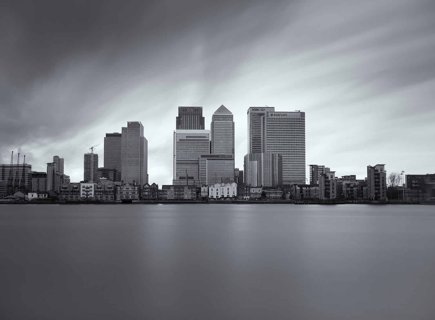 A bridge over a body of water with a city in the background