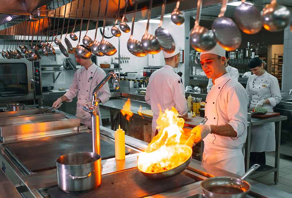 A man cooking in a kitchen preparing food