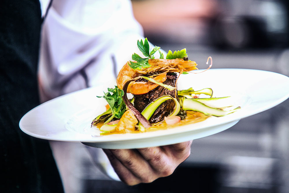 A person sitting at a table with a plate of food