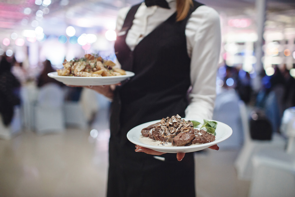 A person sitting at a table with a plate of food