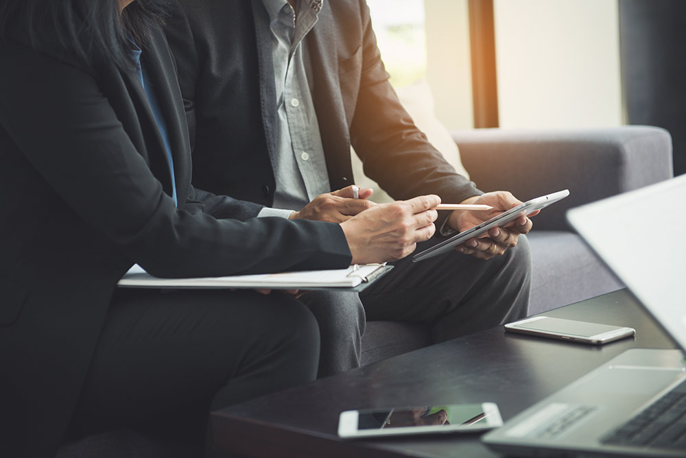 A person sitting at a table using a laptop