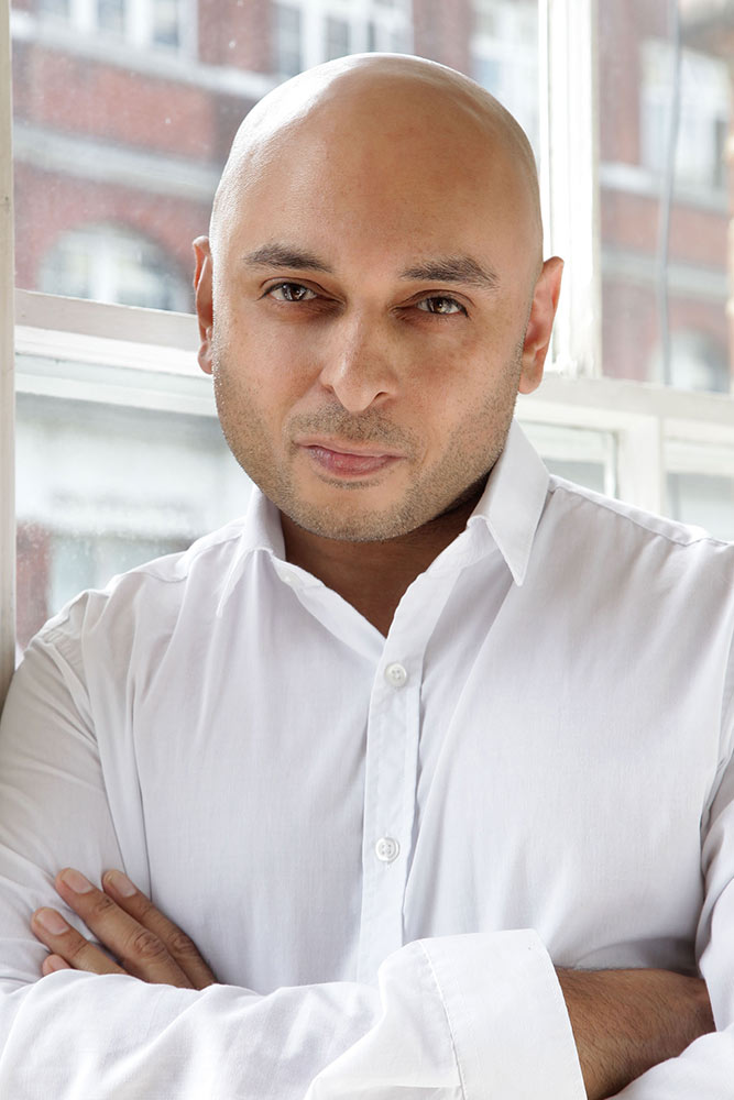 A man wearing glasses and looking at the camera