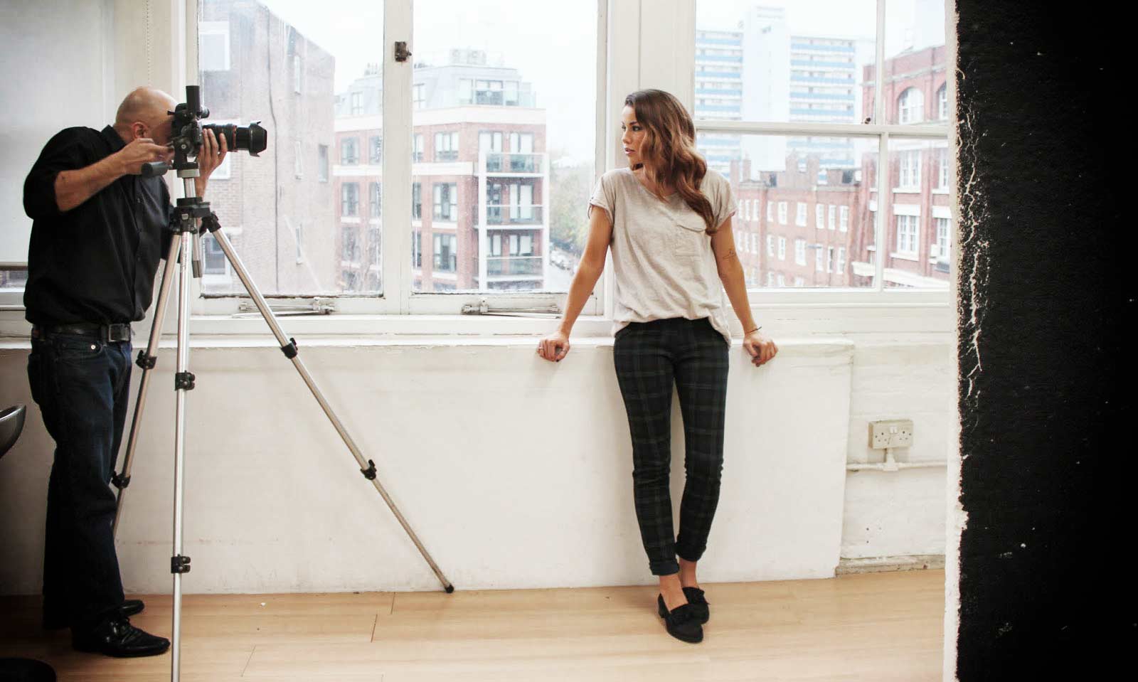 A man and a woman standing in front of a building