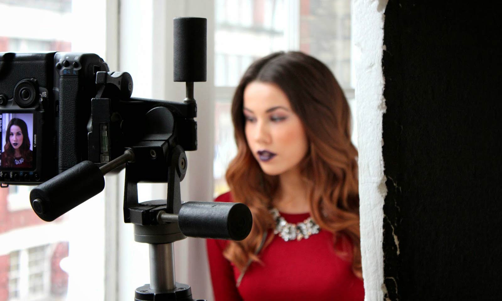 A person standing in front of a mirror posing for the camera