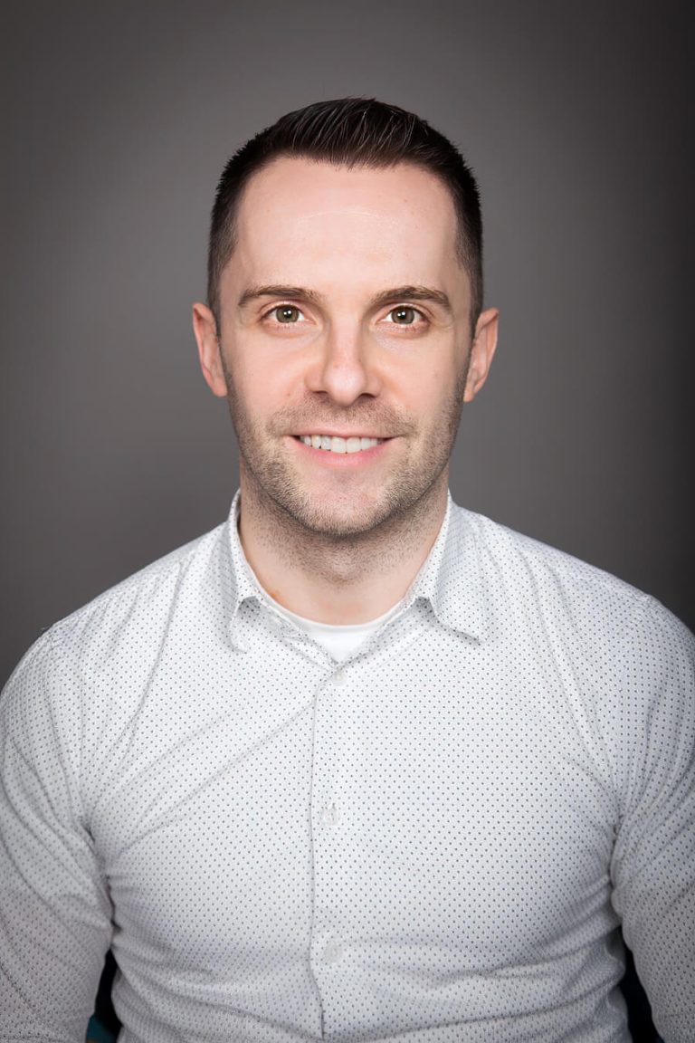 A man wearing glasses and looking at the camera