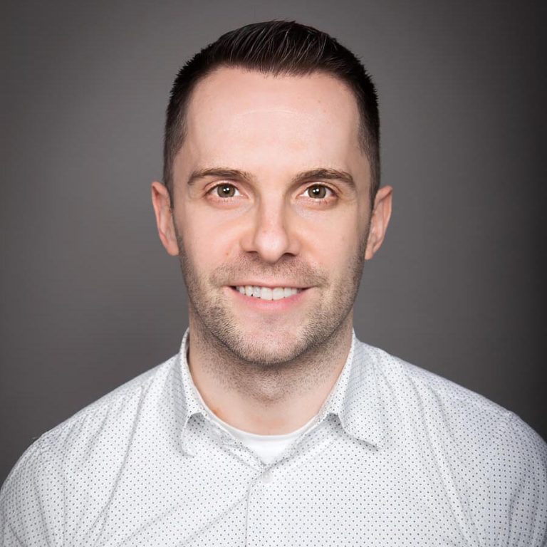 A man wearing glasses and looking at the camera