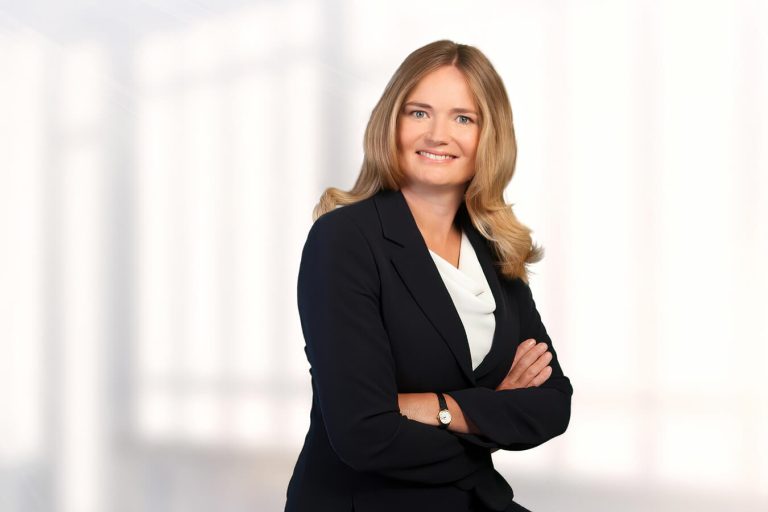 A woman wearing a suit and tie