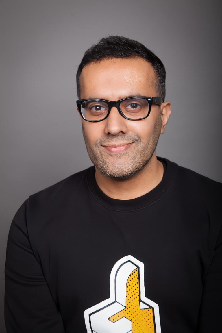 A man wearing glasses and looking at the camera