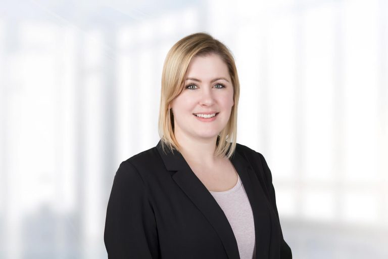 A woman standing in front of a window posing for the camera