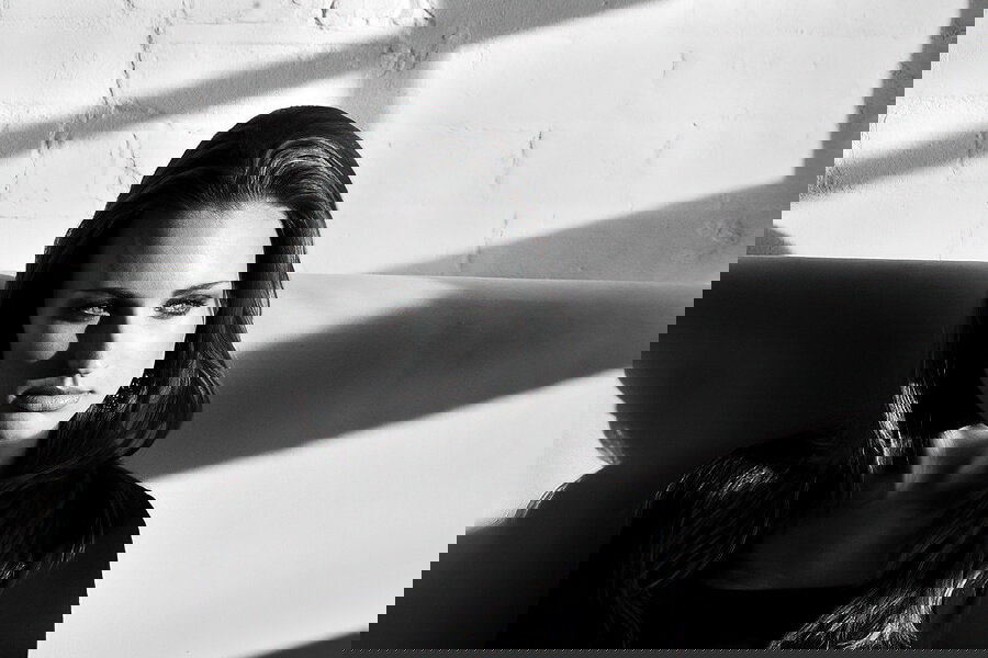 A woman standing in front of a window